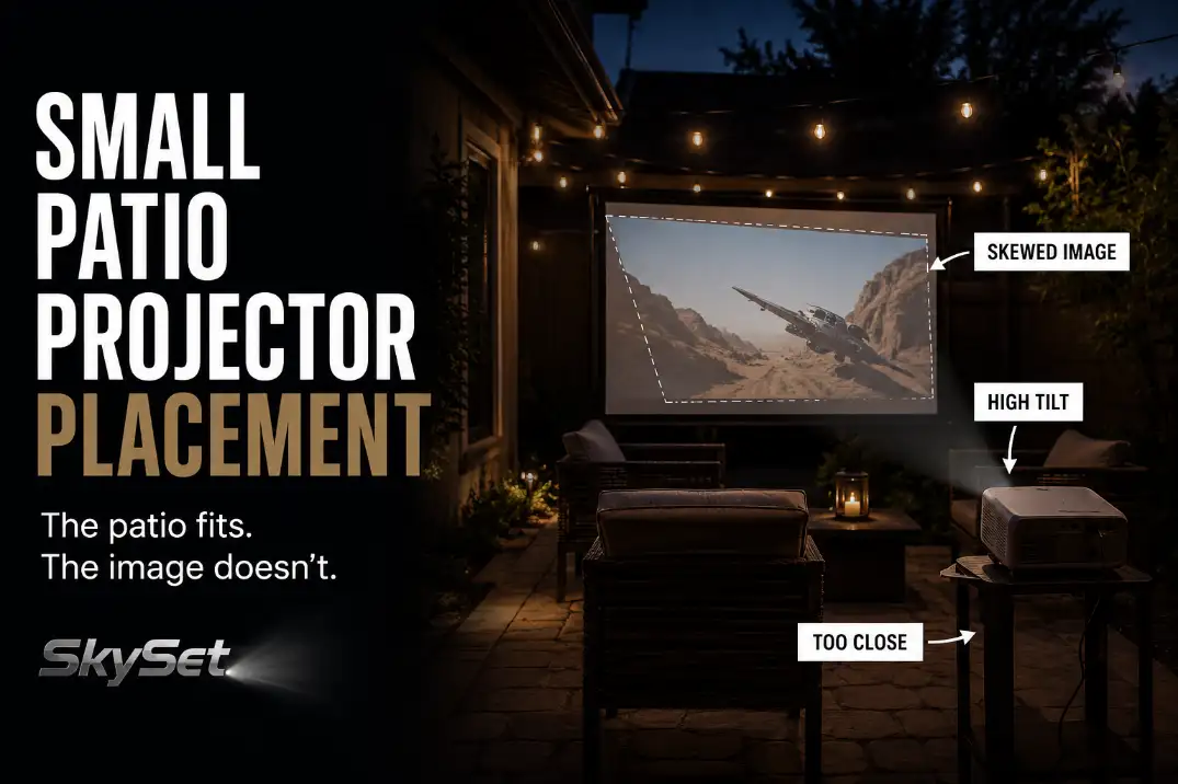 Small patio projector placed too close and too high, causing a skewed outdoor movie image on a backyard screen.
